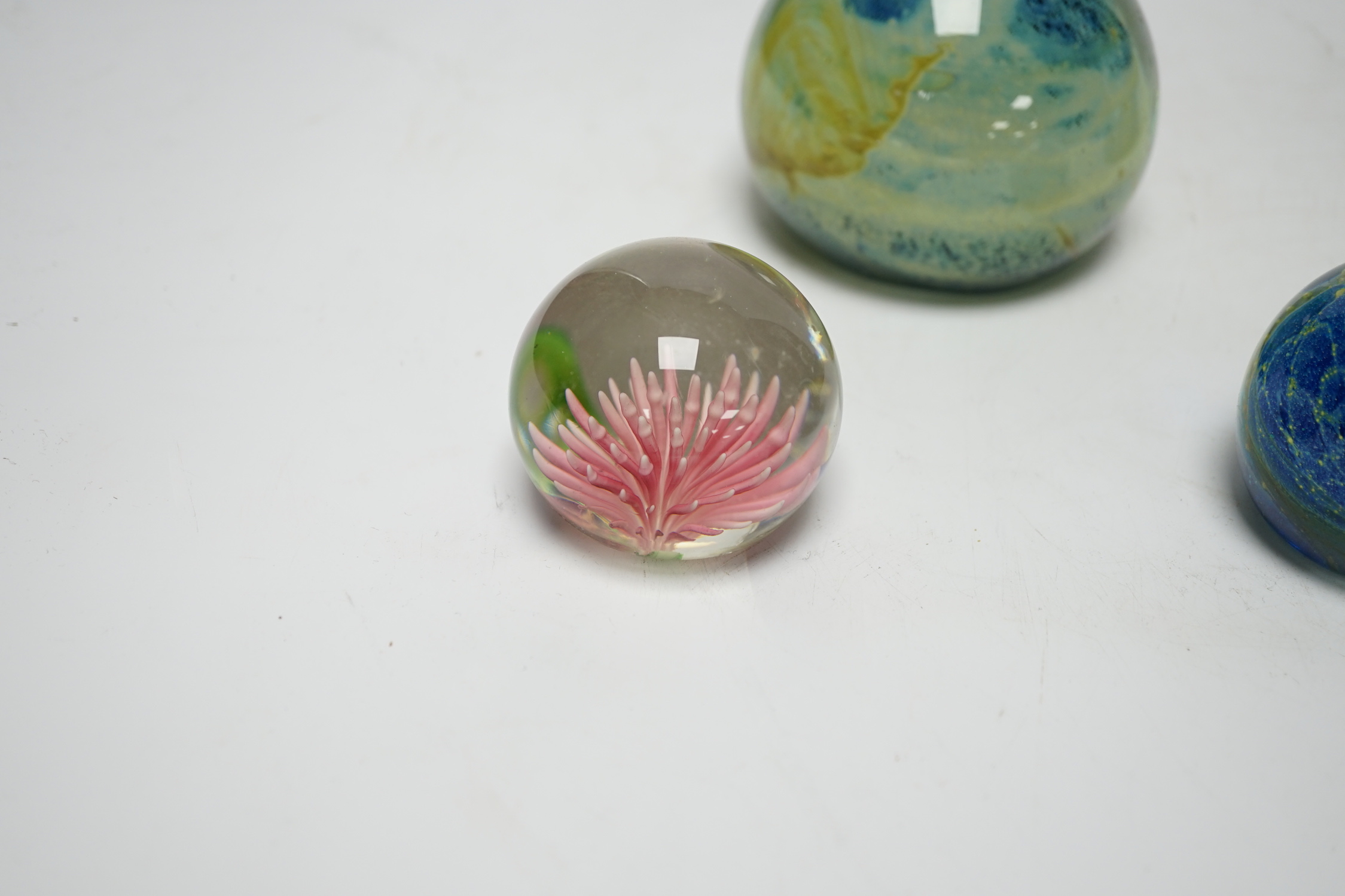 Three Mdina style glass paperweights and a Chinese paperweight (4)